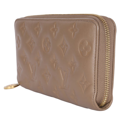 Lambskin Embossed Monogram Coussin Zippy Wallet Taupe